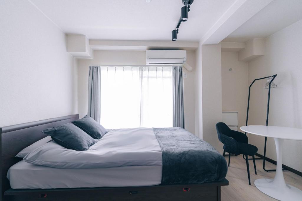 Ένα ή περισσότερα κρεβάτια σε δωμάτιο στο unito residence KYOTO Takasegawa