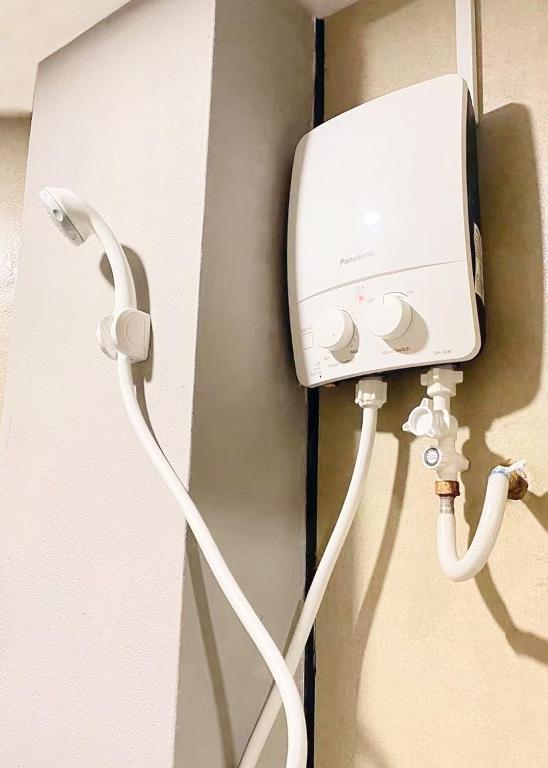 a white power cord hooked up to a wall at Hi-Inn in Miri