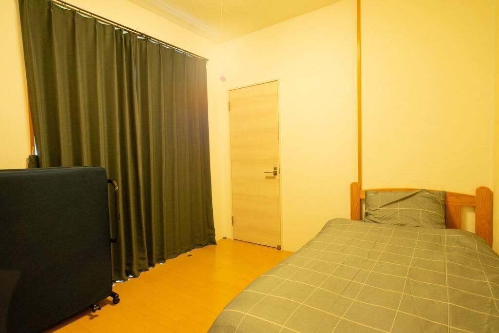 Postel nebo postele na pokoji v ubytování ニライハウス大宜味