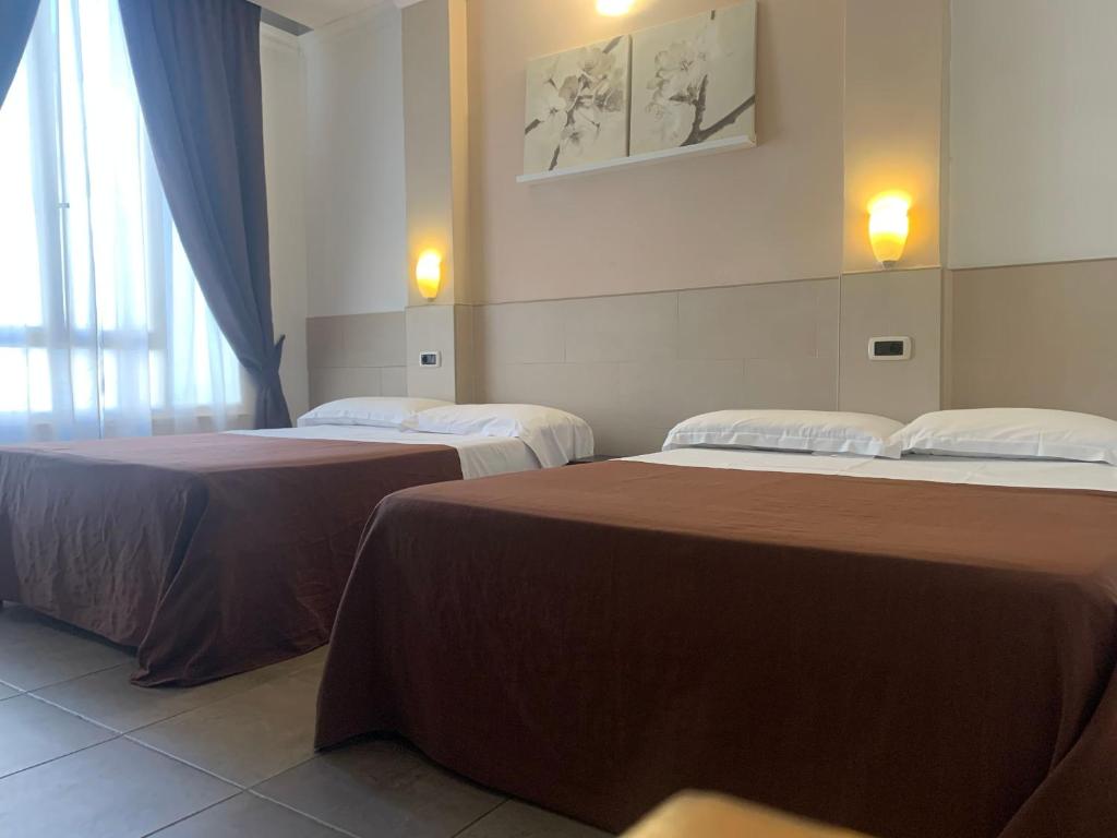 Postel nebo postele na pokoji v ubytování Hotel Indipendenza