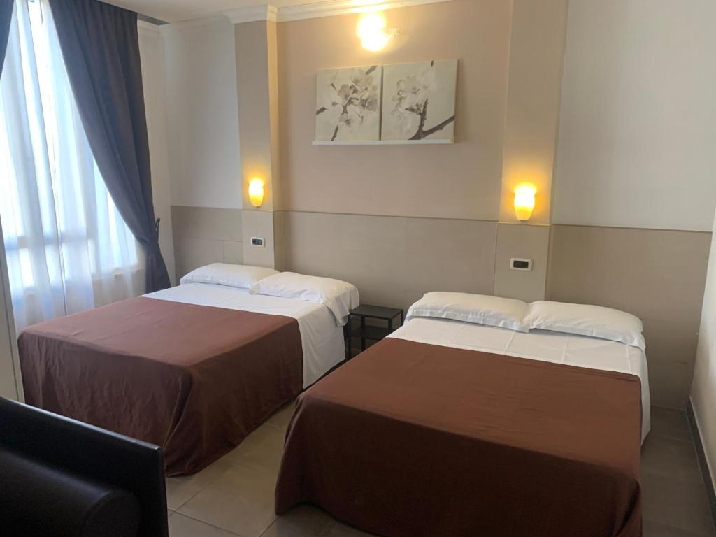 Postel nebo postele na pokoji v ubytování Hotel Indipendenza