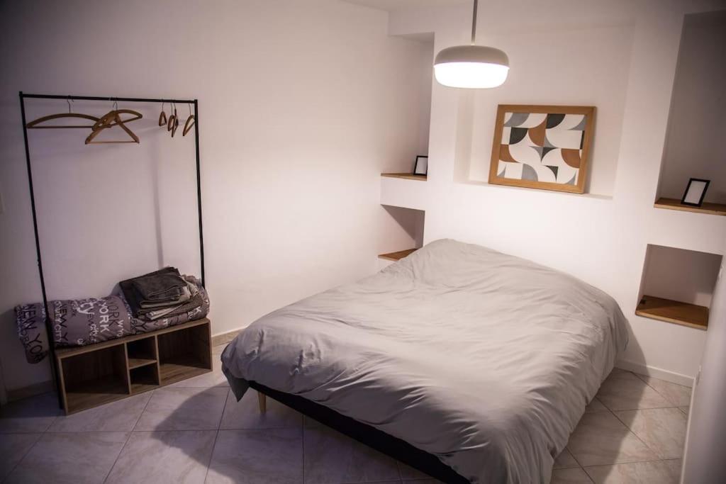 Katil atau katil-katil dalam bilik di Appartement au cœur du village