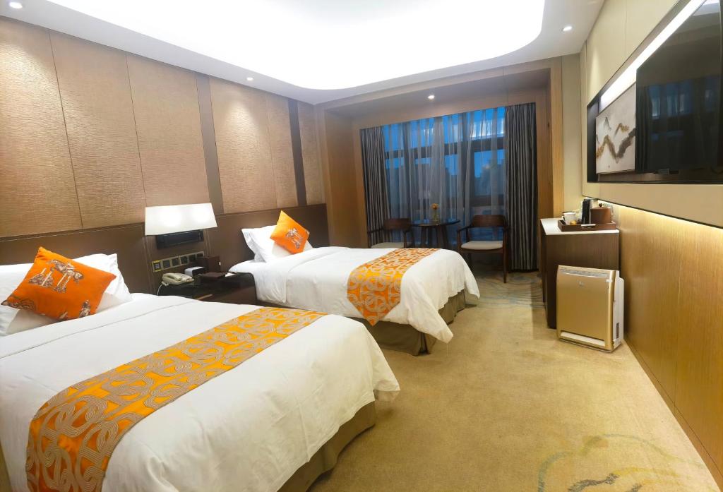Postel nebo postele na pokoji v ubytování Jin Jiang Pine City Hotel
