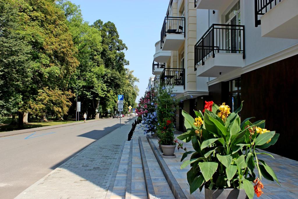 a street with flowers on the side of a building at NOVERA Apartments - #C in Turčianske Teplice