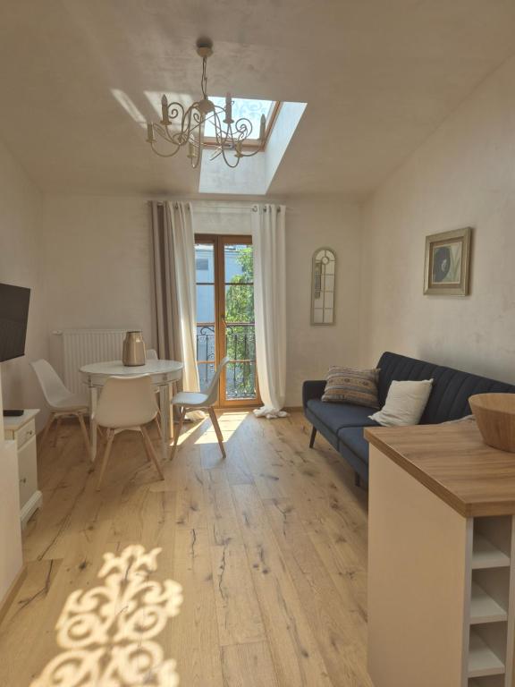 a living room with a blue couch and a table at Aparthotel Miodowa 25 in Kraków