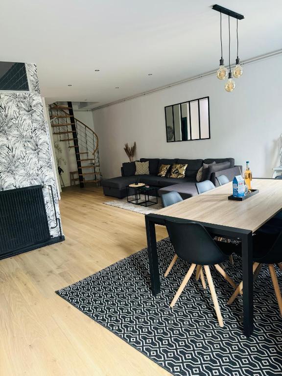 un salon avec une table et un canapé dans l'établissement Là-Haut, à Royan