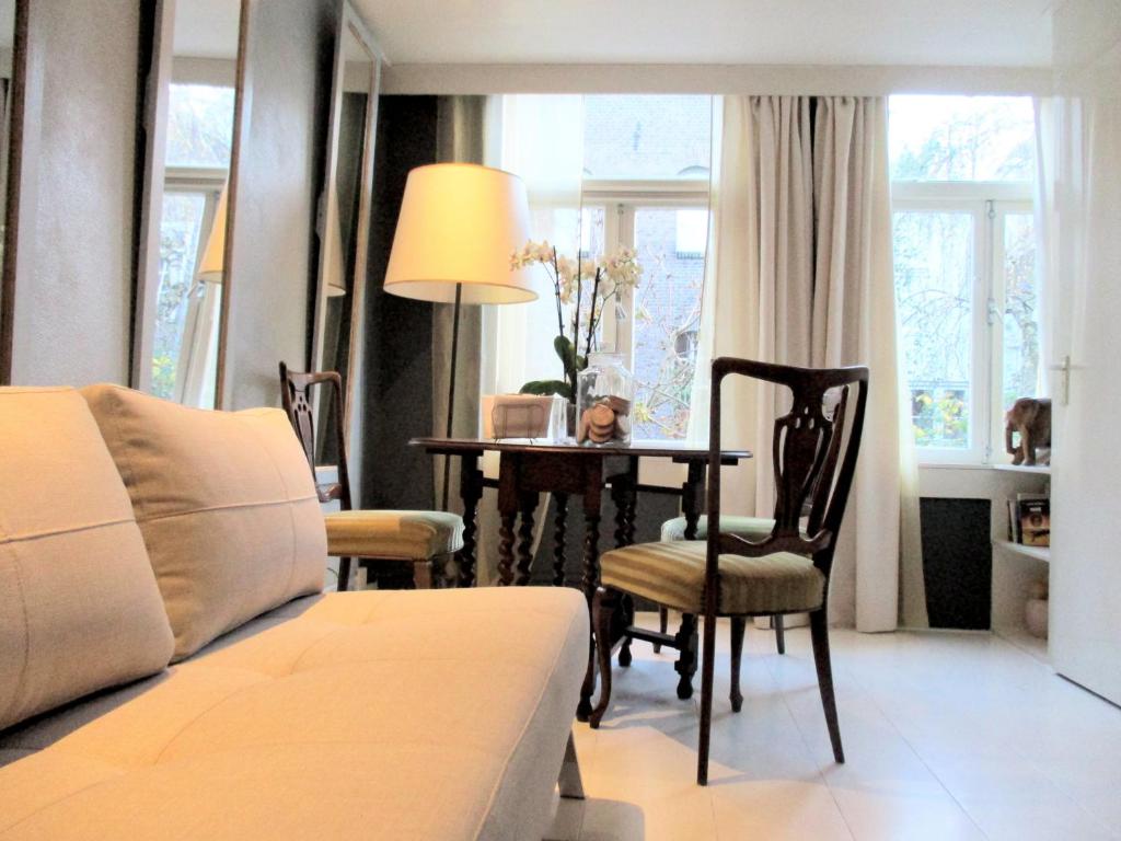 a bedroom with a bed and a table and chairs at Miss Jordaan for Quiet Travellers in Amsterdam