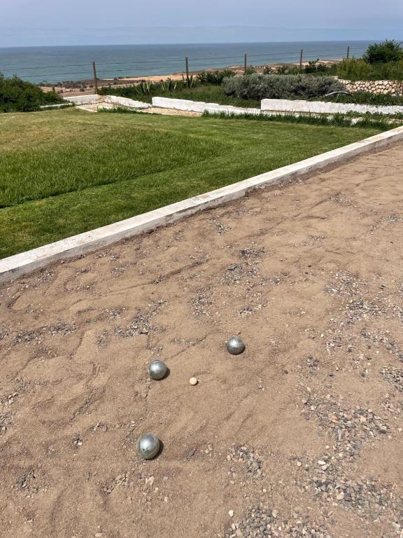two balls on the ground on a dirt road at Villa La Falaise in Oualidia