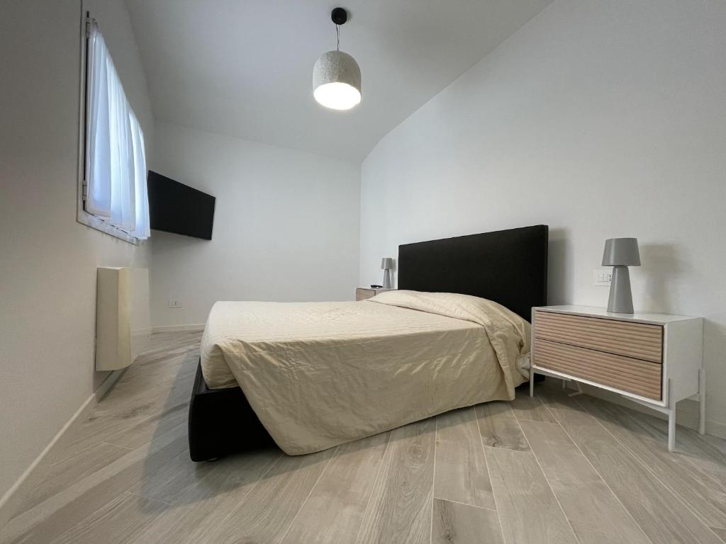 A bed or beds in a room at Gli Scogli Luxury Residence Hotel