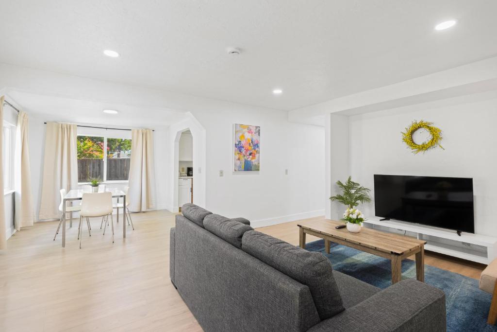 a living room with a couch and a tv at # Marbella Lane - Modern Cabin-style 2BR Home in Campbell