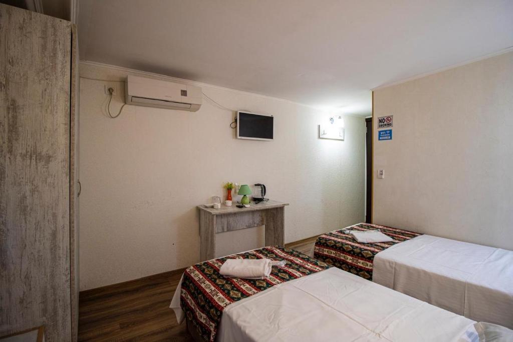 Postel nebo postele na pokoji v ubytování HotelHarmony