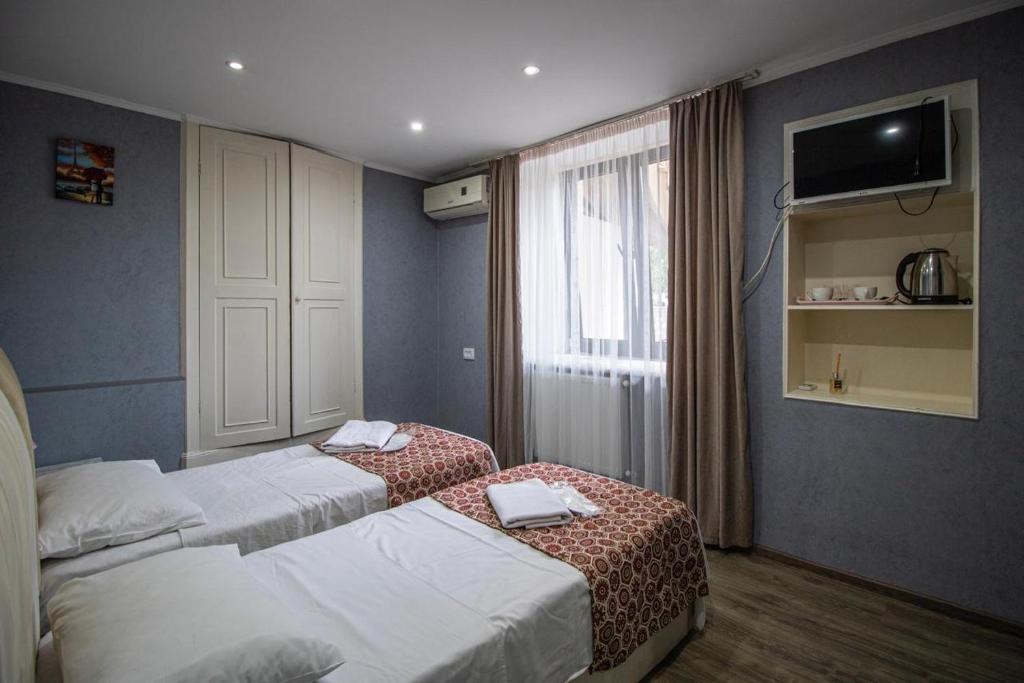 Postel nebo postele na pokoji v ubytování HotelHarmony