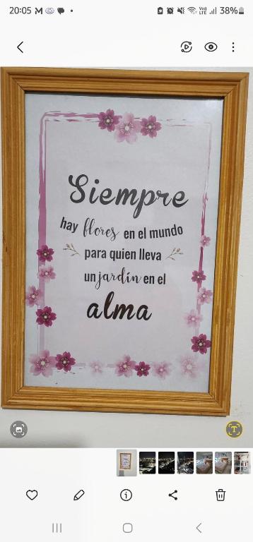 a framed picture of a sign with flowers on it at DEPARTAMENTO ACOSTA 1 in Paraná