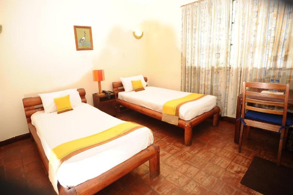 Postel nebo postele na pokoji v ubytování Kenya Comfort Hotel