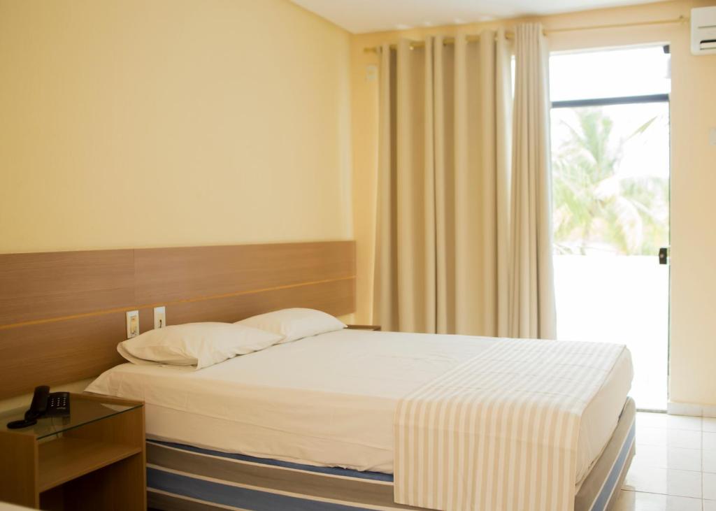 Postel nebo postele na pokoji v ubytování Fiesta Park Hotel