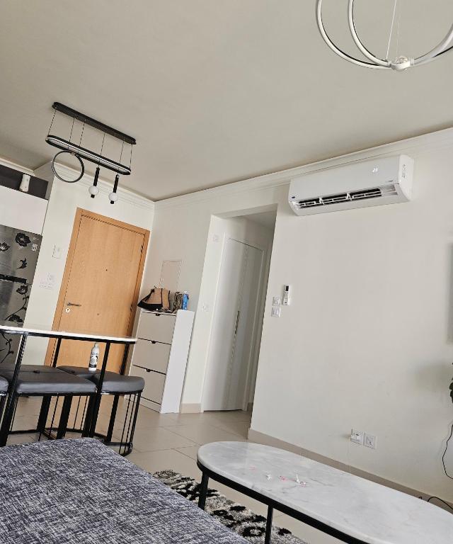 a room with a table and chairs in a room at Marassi luxury 2 bedroom in El Alamein