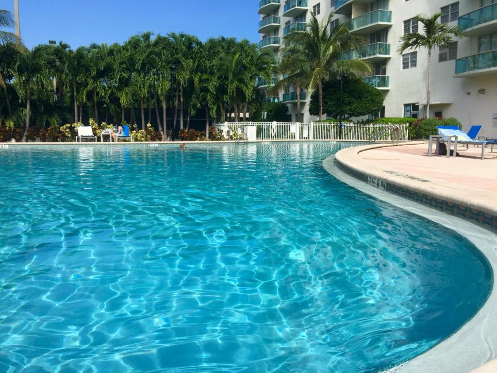 Ocean Reserve Miami Luxury Rentals في ميامي بيتش: مسبح كبير بمياه زرقاء في منتجع