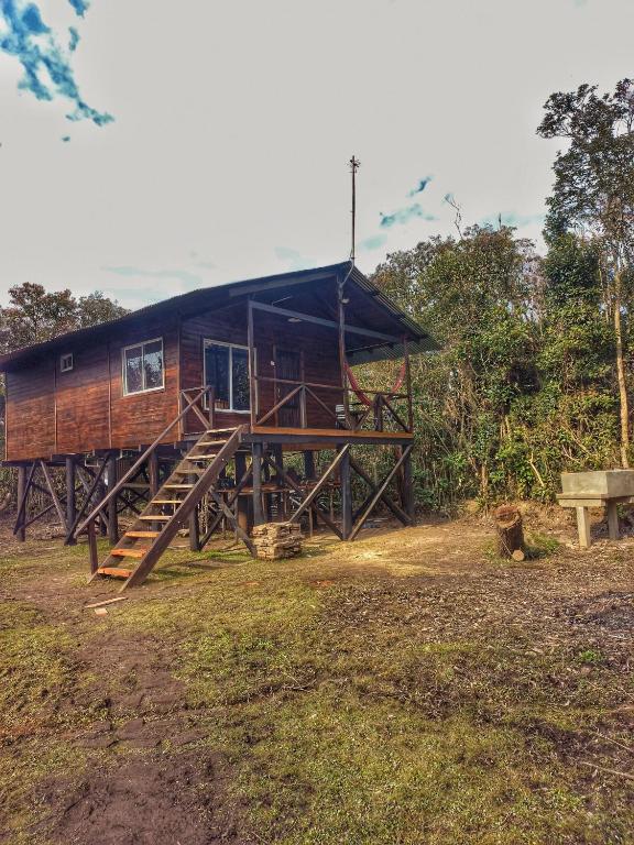 a wooden house with a staircase leading to it at Cabaña Megara en Complejo Marea in Tigre