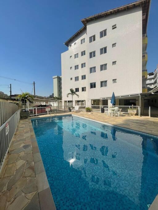 a large swimming pool in front of a building at Recanto das Ondas in Ubatuba