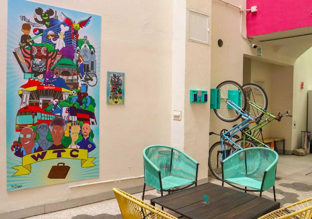 A communal seating corner with colorful artwork and bicycle displays.