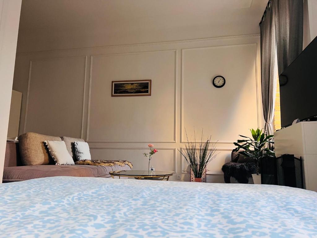 a living room with a bed and a couch at Cozy apartment in Rīga