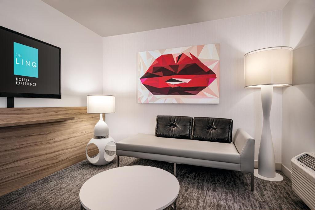 a living room with a red lips painting on the wall at The LINQ Hotel and Casino in Las Vegas