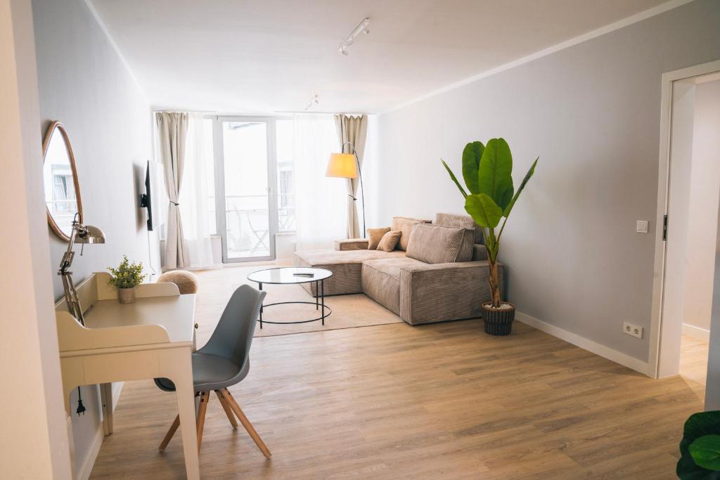 a living room with a couch and a table at RR - NEW - Beautiful Apartment 80qm - Lift - WIFI in Kröllwitz