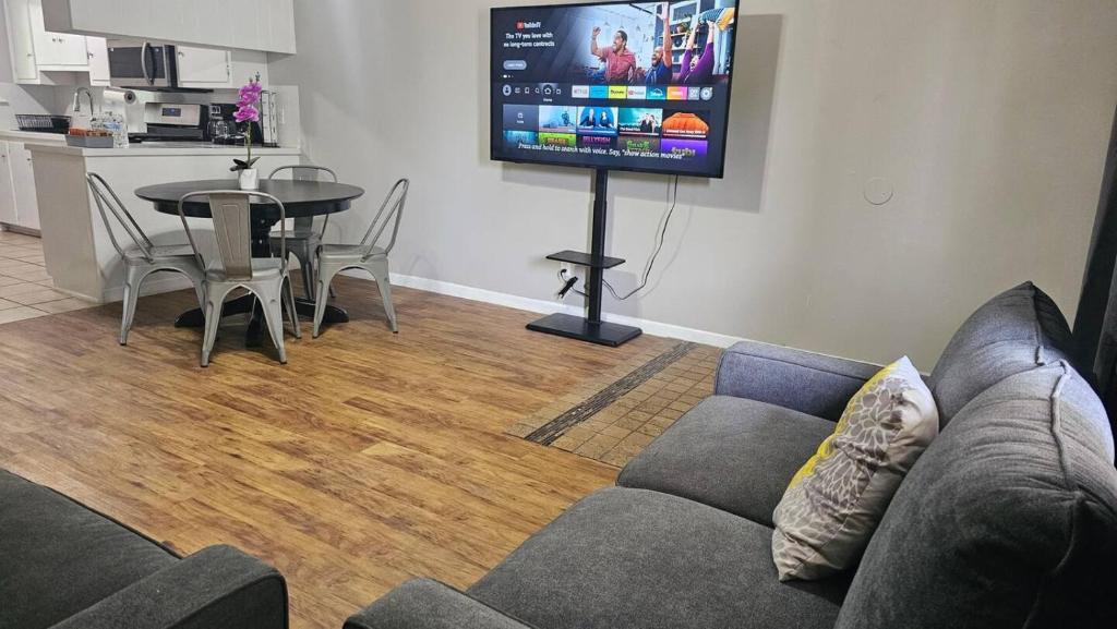 a living room with a couch and a table and a tv at Homey 2br Home Near Downtown & Airport in Austin