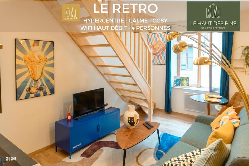 a living room with a blue couch and a staircase at Hypercentre, calme, vintage - Le Rétro in Pontarlier