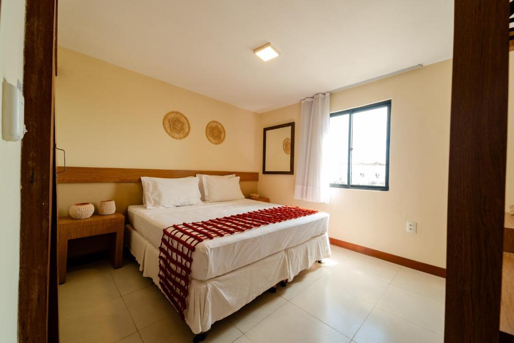 a bedroom with a bed and a window at Fortmar Hotel in Fortaleza