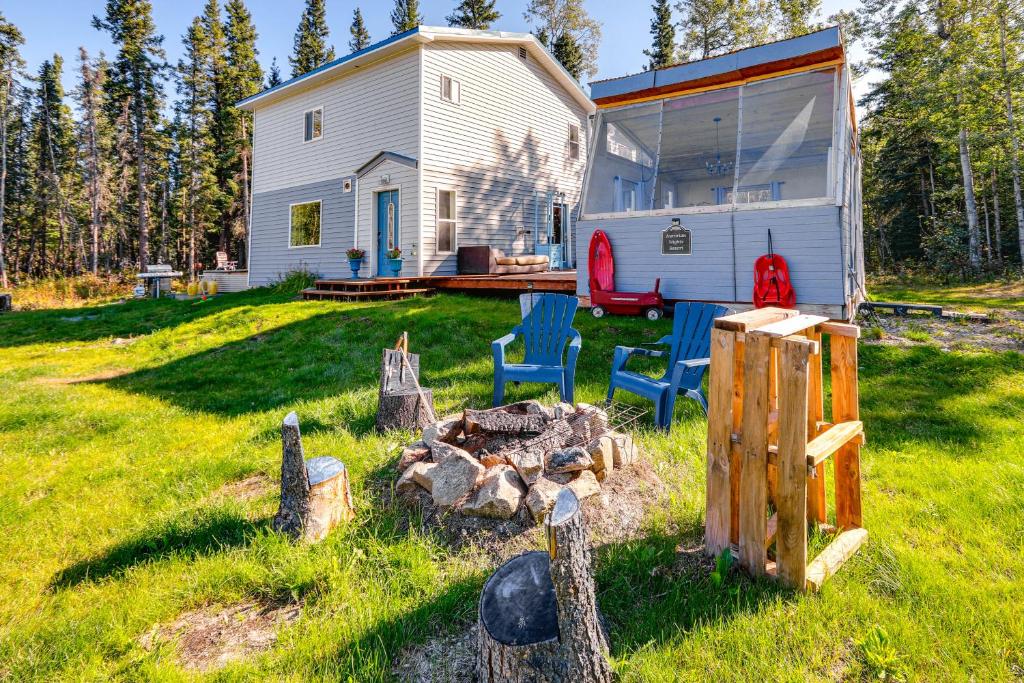a tiny house with a patio and a fire place at Delta Junction Retreat with Northern Lights Cabin! in Delta Junction