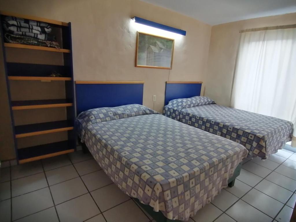 Postel nebo postele na pokoji v ubytování Hotel Vagabundo Expo Guadalajara