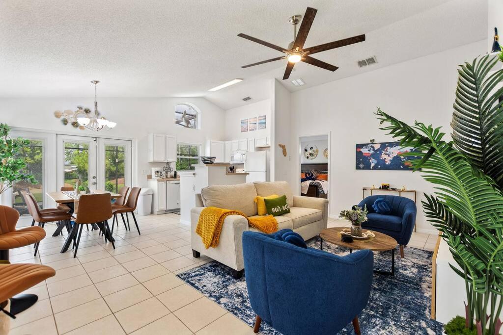 a living room with a couch and a table at Luxurious 3BR Pool, Golf Views, Disney, Legoland in Haines City