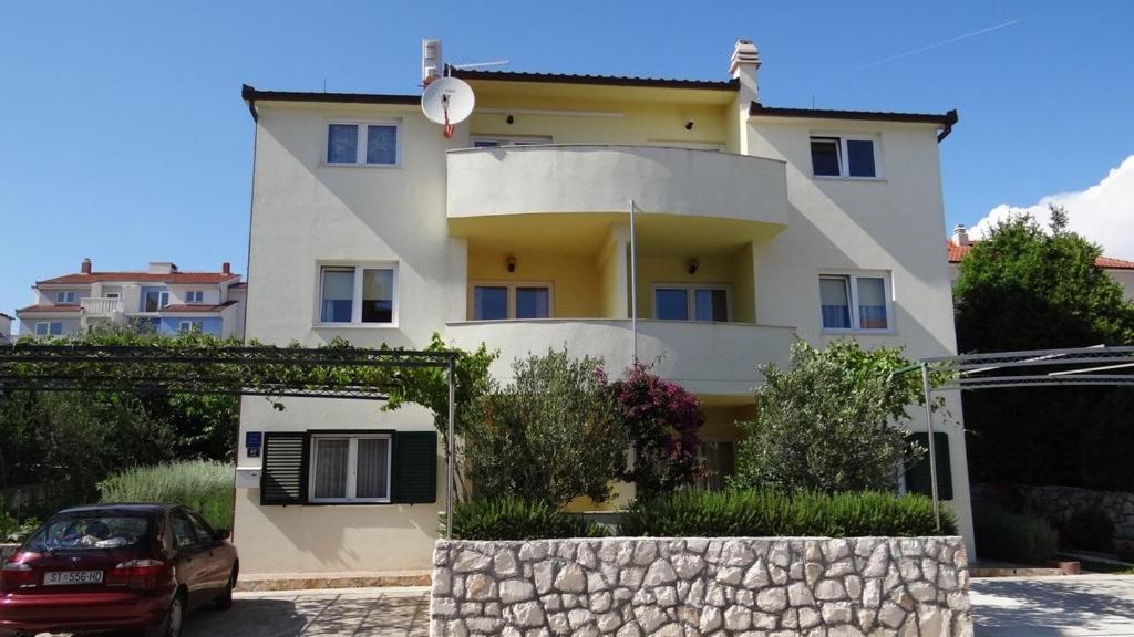 a house with a car parked in front of it at Apartment in Okrug Gornji 6167 in Trogir
