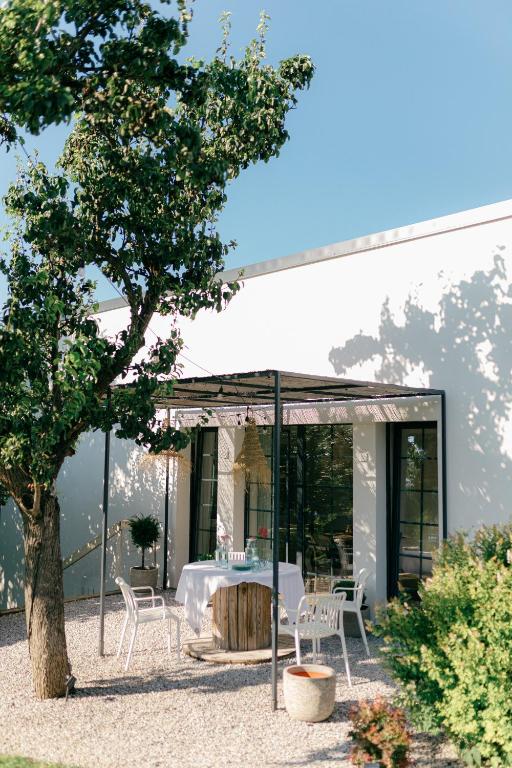 a glass extension of a house with a table and chairs at Ateliér v raji in Spišské Tomášovce