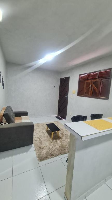 a living room with a table and a couch at Apartamento central in Natal