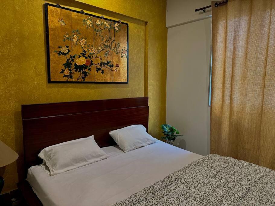 a bedroom with a bed and a painting on the wall at Oasis Serenity Seaview DHA Phase 6 in Karachi