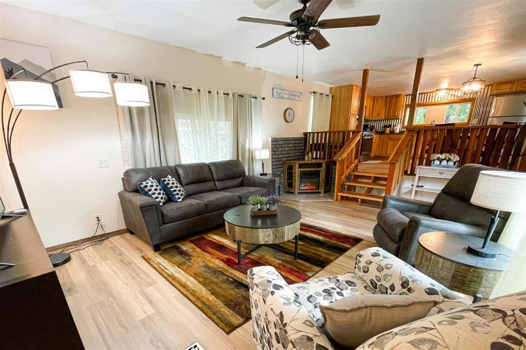 a living room with a couch and a table at Canyon Creek Casita in Ruidoso