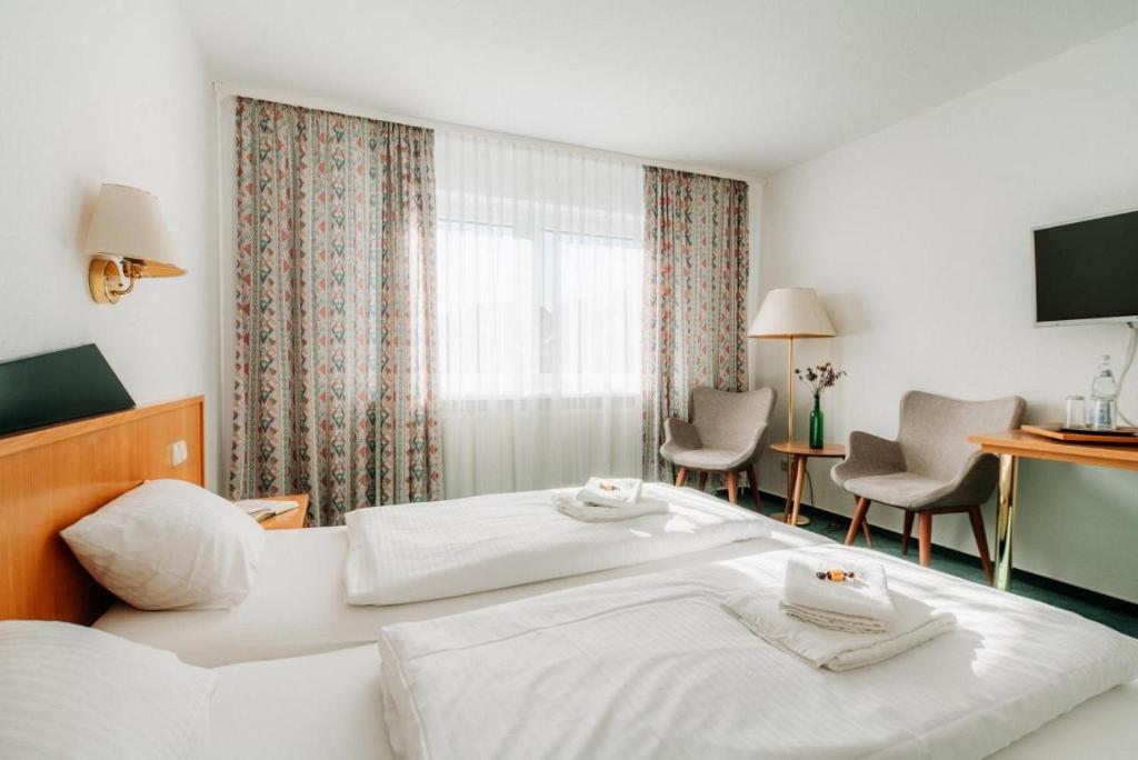 Postel nebo postele na pokoji v ubytování Hotel zur Radau