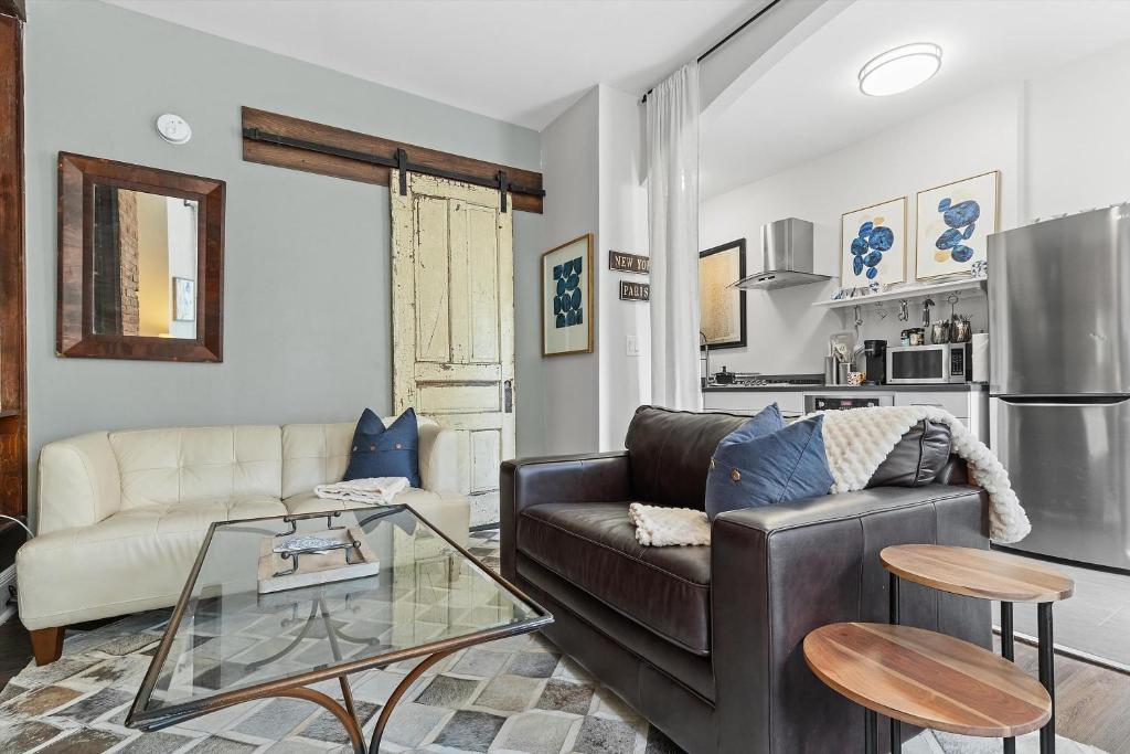 a living room with a couch and a table at Beautiful 1-BR Flat Nestled Between Dupont & Logan in Washington, D.C.