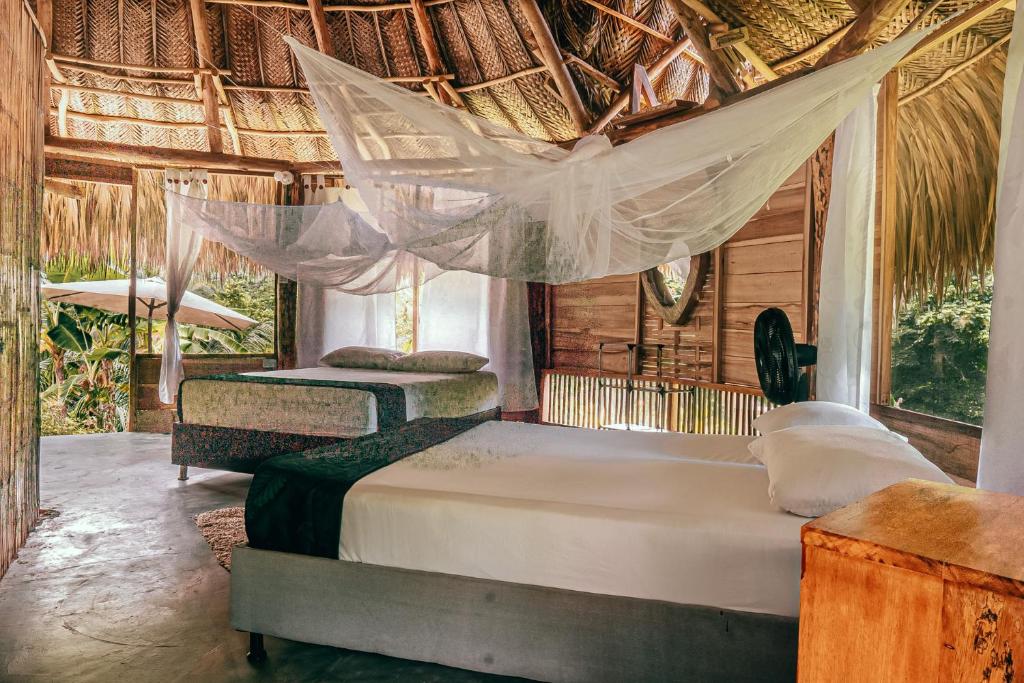 Ein Bett oder Betten in einem Zimmer der Unterkunft Magic Green Dentro del Parque Tayrona