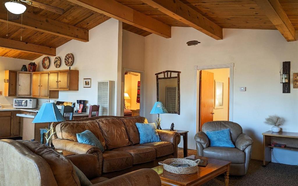 a living room with a couch and two chairs at Mama Bears Cabin in Ruidoso