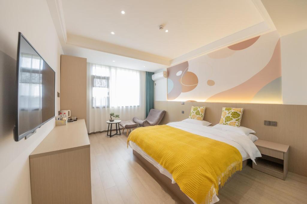 a bedroom with a bed with a yellow blanket at 乌镇闲情逸致精品民宿 in Wujiaqiao