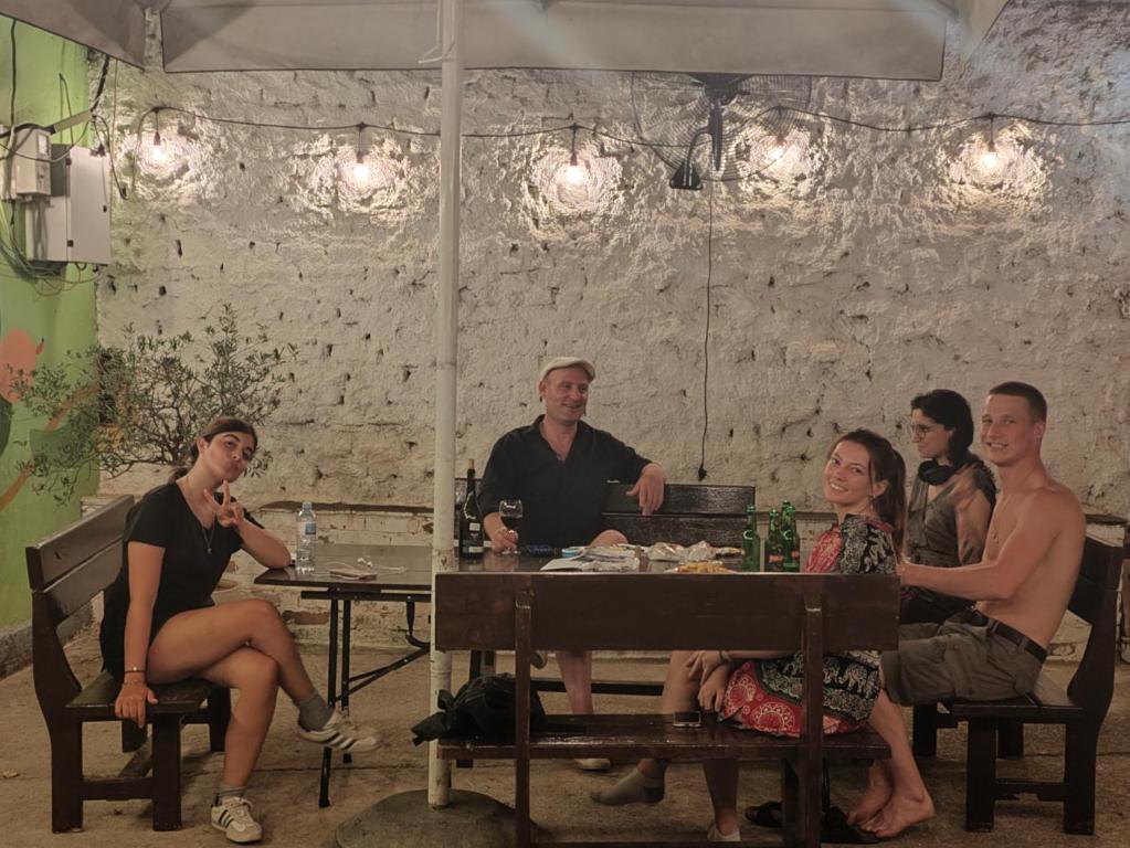 a group of people sitting around a table at D1 Hostel in Tirana