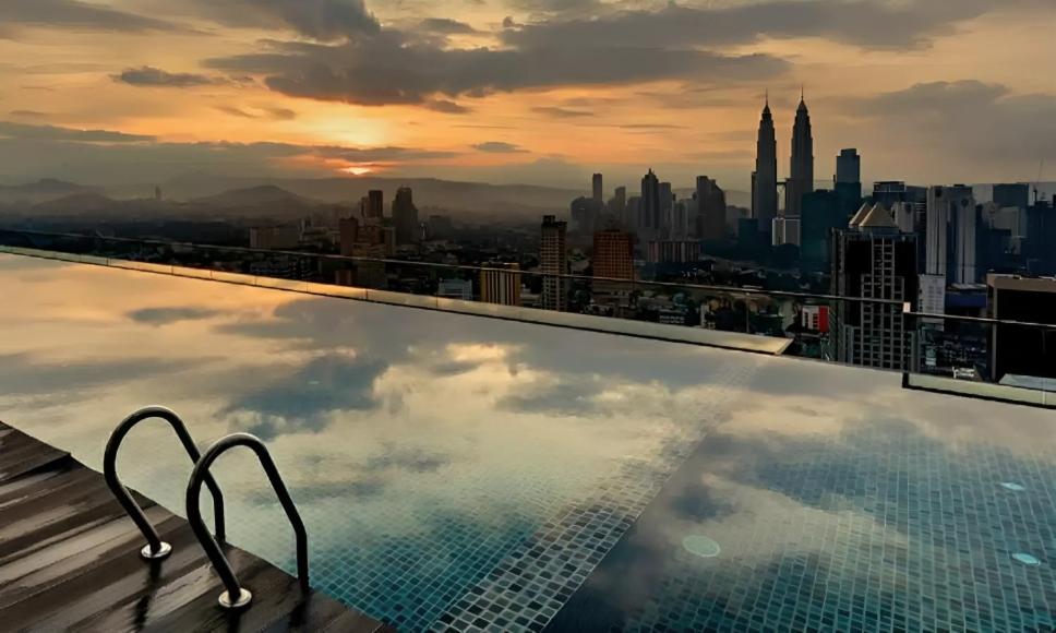 a swimming pool on top of a building with a city skyline at Regalia Infinity Skypool in Kuala Lumpur