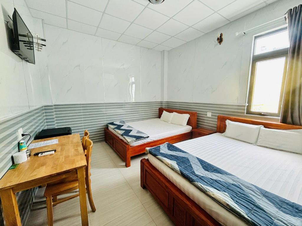 Postel nebo postele na pokoji v ubytování Hotel Sen Việt Bạc Liêu