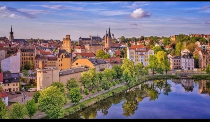 a view of a city with a bridge over a river at Monteurwohnung, Arbeiterunterkunft, Pension, Gästewohnung in Altenburg , Kurz u Langzeitmiete in Altenburg