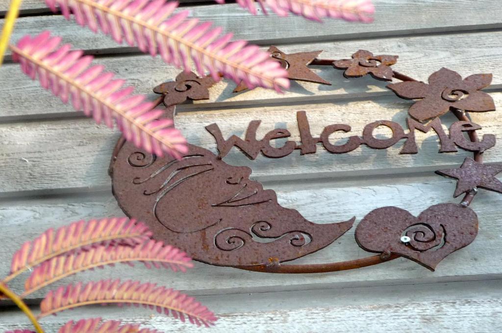 a welcome sign with a heart and the word welcome at Magnolia Petal in Ganges