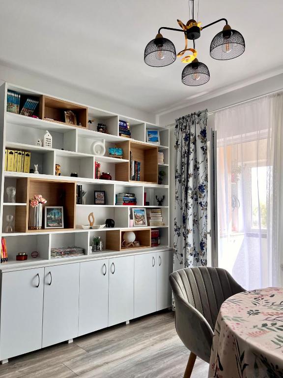 a room with a large white book shelf at Comfortable Baia Mare Apartment in Baia Mare