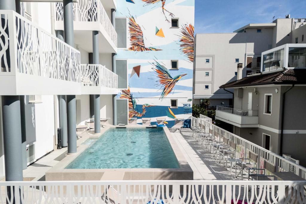a view of the pool from the balcony of a building at Hotel Marzia Holiday Queen in Caorle